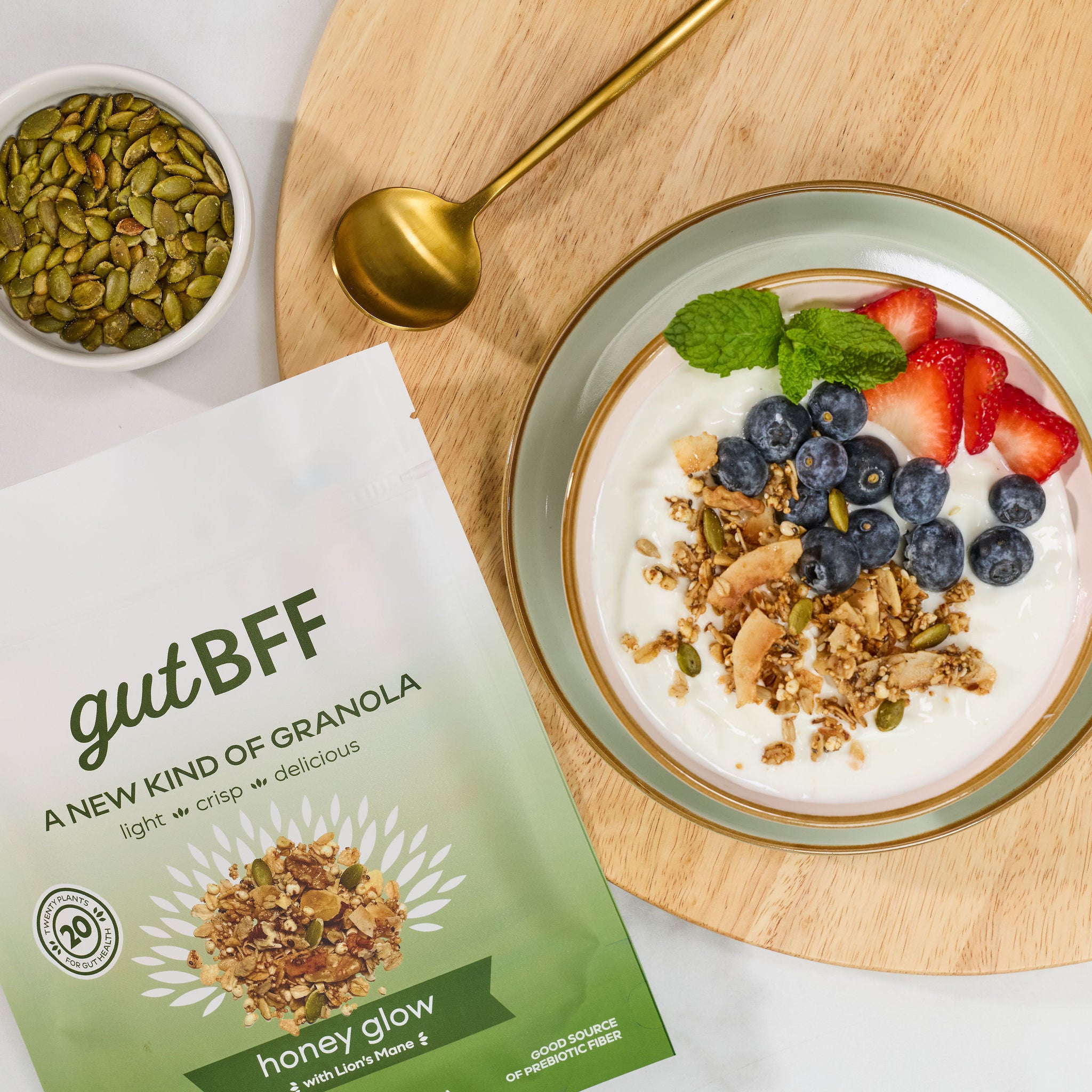 A delicious, gut-friendly breakfast bowl with yogurt topped with gutBFF Honey Glow granola and berries.